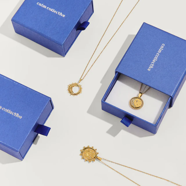 Gold necklaces shown in the distinctive blue box packaging